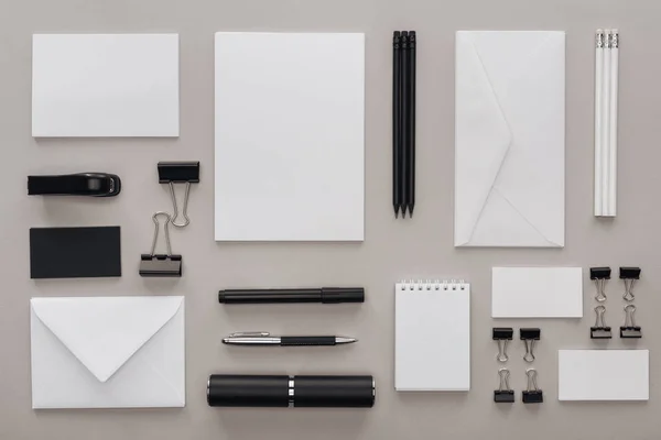 Flat lay with black and white stationery on grey background — Stock Photo