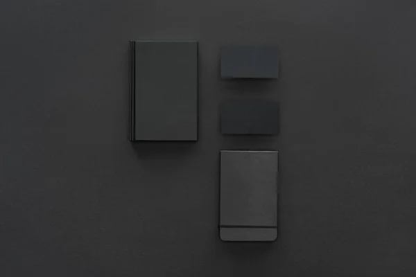 Top view of notebooks and cards on black background — Stock Photo