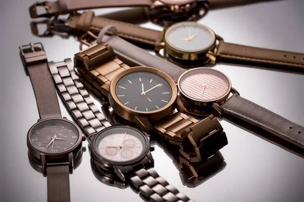 Selective focus of luxury wristwatches on grey background — Stock Photo
