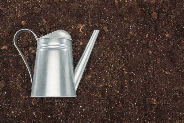 Top view of watering can on ground, protecting nature concept — Stock Photo