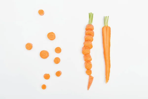 Top view of carrot slices, sliced and cut carrots isolated on white — Stock Photo