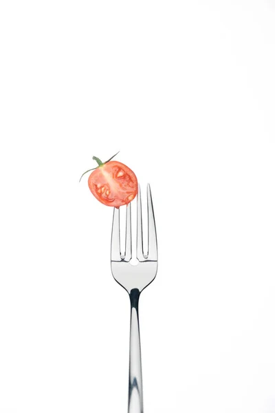 Half of fresh red cherry tomato on fork isolated on white — Stock Photo