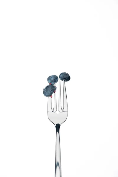 Whole fresh ripe blueberries on fork isolated on white — Stock Photo