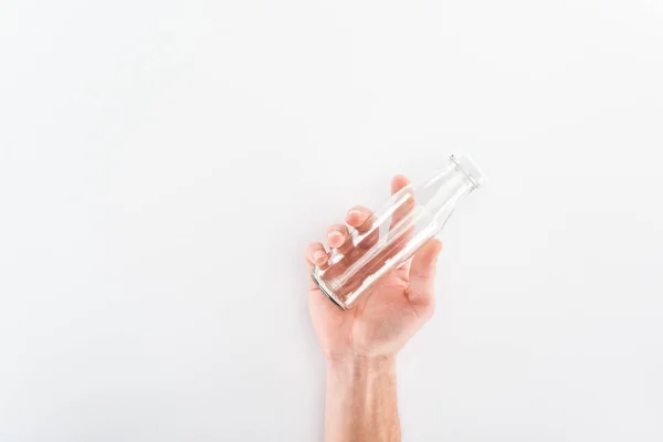 Cropped view of man holding empty glass bottle — Stock Photo