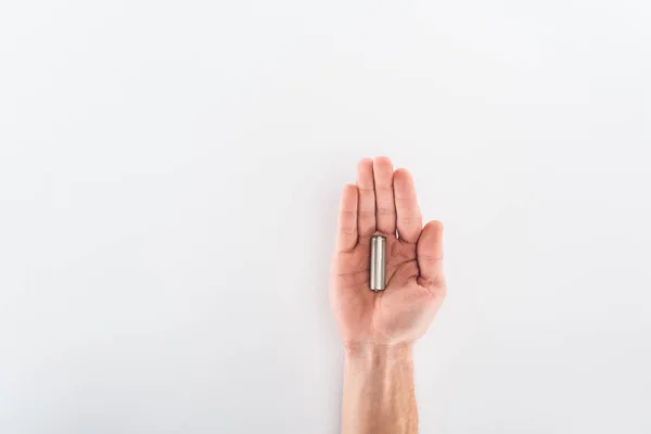 Partial view of man holding battery on grey background — Stock Photo