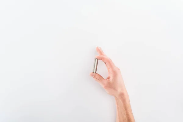 Cropped view of man holding battery on grey background — Stock Photo