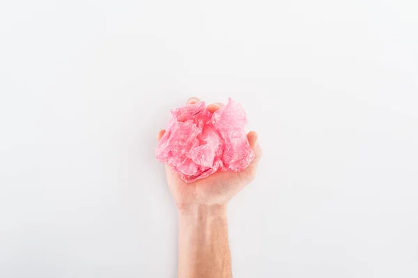 Partial view of man holding pink plastic bag on grey background — Stock Photo