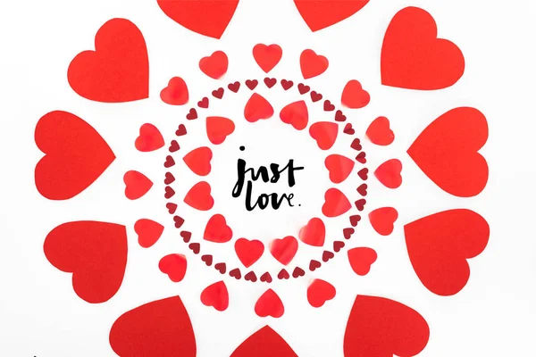 Elevated view of circles made of red heart symbols isolated on white, st valentine day concept with 