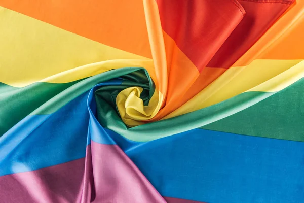 Top view of rainbow flag creased in spiral shape, lgbt concept — Stock Photo