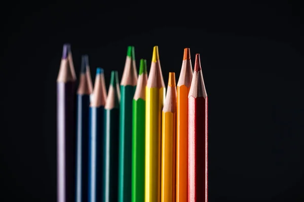 Selective focus of sharpened multicolor pencils isolated on black, lgbt concept — Stock Photo