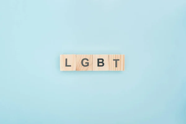 Top view of lgbt lettering made of wooden blocks on blue background — Stock Photo