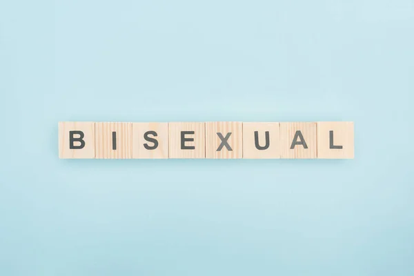 Top view of bisexual lettering made of wooden cubes on blue background — Stock Photo