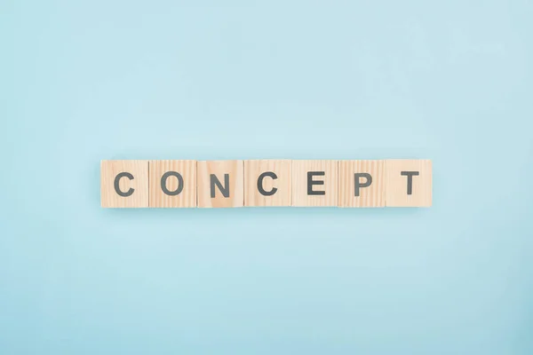 Top view of concept lettering made of wooden cubes on blue background — Stock Photo