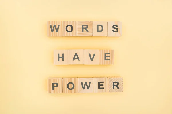 Top view of phrase words have power lettering with wooden cubes on yellow background — Stock Photo