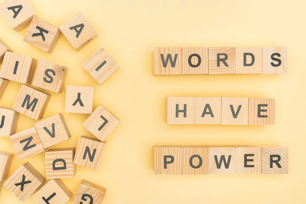 Top view of phrase words have power lettering with wooden cubes on yellow background — Stock Photo