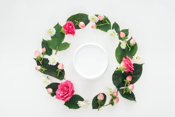 Draufsicht der kreisförmigen Komposition mit Blättern, Blüten und Schönheitscreme isoliert auf Weiß — Stockfoto