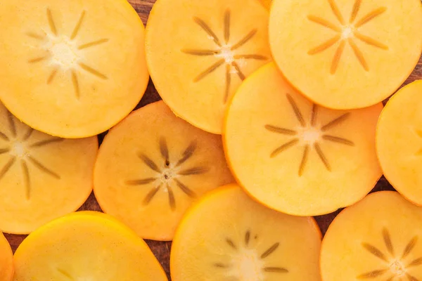 Top view of orange cut tasty and sweet persimmons — Stock Photo