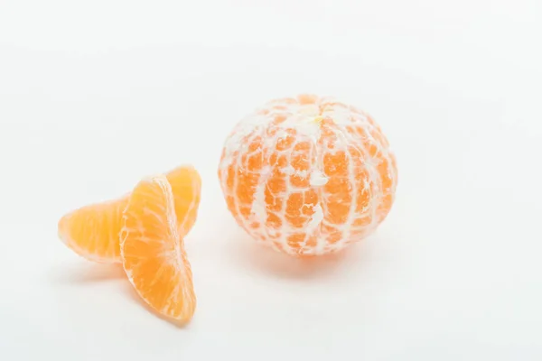 Rodajas de mandarina y fruta entera naranja madura sobre fondo blanco - foto de stock