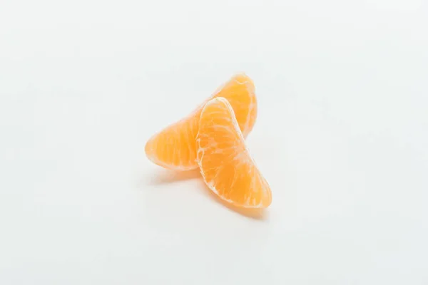 Ripe bright orange tangerine slices on white background — Stock Photo