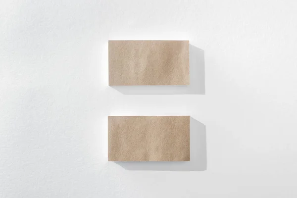 Top view of empty brown cards on white background with copy space — Stock Photo