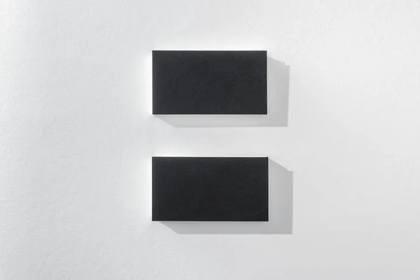 Top view of black cards on white background with copy space — Stock Photo