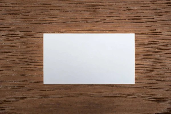 Top view of empty card on wooden table with copy space — Stock Photo