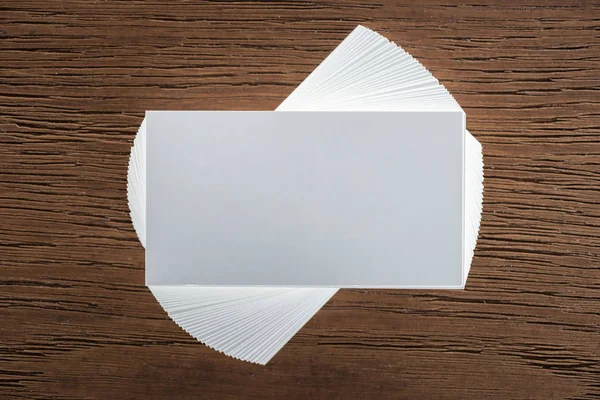 Top view of blank card on wooden surface with copy space — Stock Photo