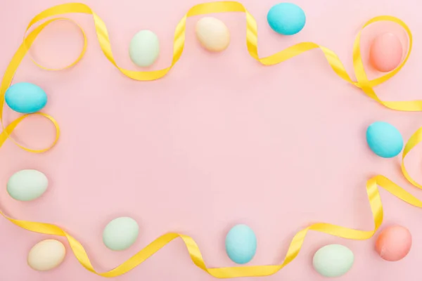 Top view of ribbon and easter eggs isolated on pink — Stock Photo