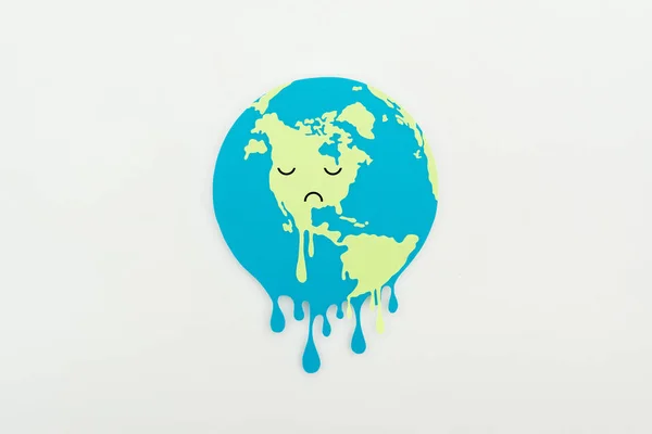 Papier de fusion coupe globe avec expression triste visage sur fond gris, concept de réchauffement climatique — Photo de stock