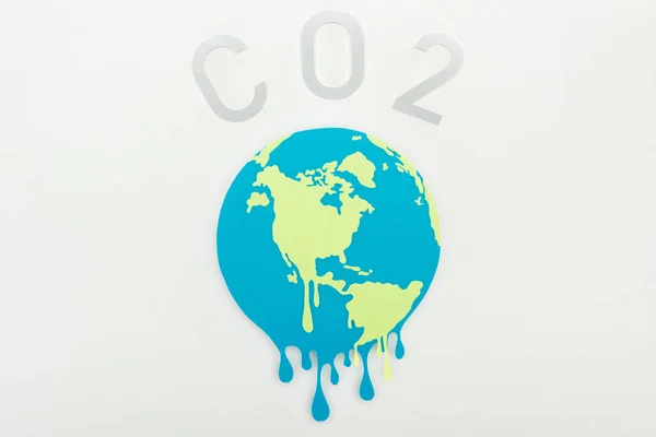 Melting paper cut globe and co2 lettering on grey background, global warming concept — Stock Photo