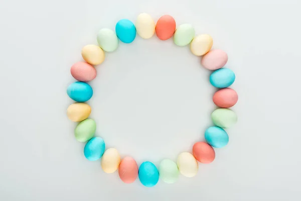 Top view of painted easter eggs as circle frame isolated on grey — Stock Photo