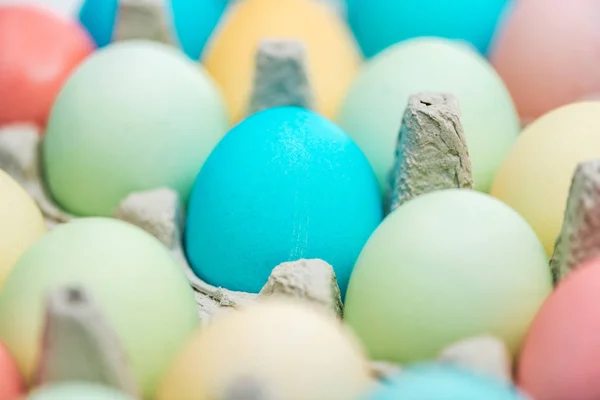 Close up of pastel easter eggs in paper containers, selective focus — Stock Photo