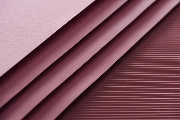 Top view of blank and pink sheets of paper on burgundy background with copy space — Stock Photo