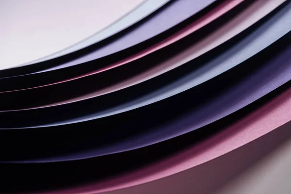 Blue, pink, burgundy and purple sheets of paper on white background — Stock Photo