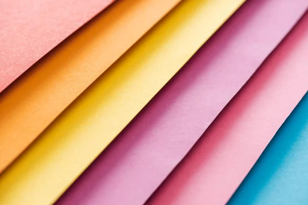 Blue, orange, burgundy, yellow, and pink sheets of paper with copy space — Stock Photo