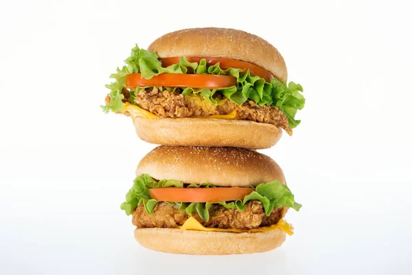 Delicious and unhealthy chicken burgers with meat isolated on white — Stock Photo