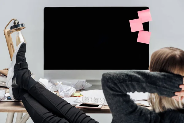 Selective focus of girl relaxing at messy workplace isolated on grey — Stock Photo