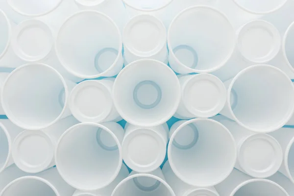 Top view of white and plastic cups on blue background — Stock Photo