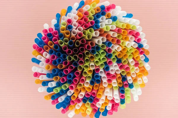 Top view of colorful and bright plastic straws isolated on pink — Stock Photo