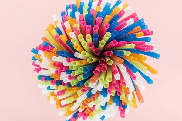 Top view of colorful and bright plastic straws isolated on pink — Stock Photo