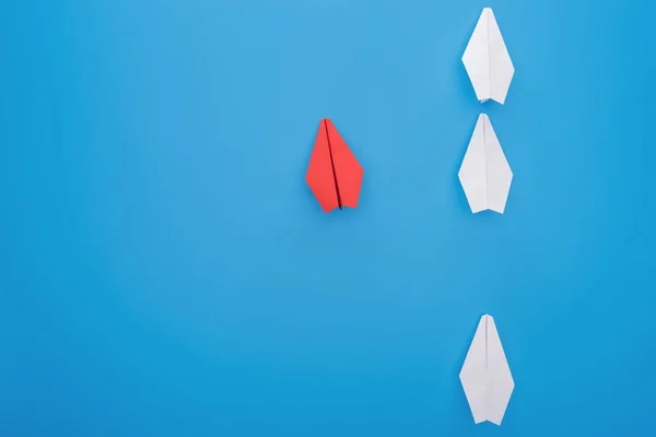 Flat lay with white and red paper planes on blue — Stock Photo