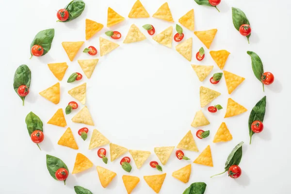 Vista dall'alto di gustosi nachos e peperoncini tagliati a fette con basilico e pomodorini — Foto stock