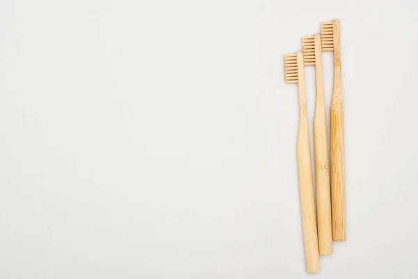 Natural bamboo toothbrushes on grey background with copy space — Stock Photo