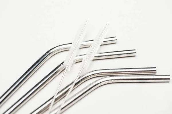 Stainless steel straws and cleaning brushes isolated on grey — Stock Photo