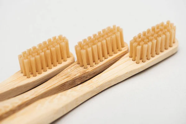 Close up view of organic bamboo toothbrushes on grey — Stock Photo