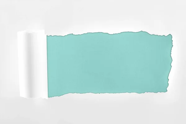 Papel branco texturizado ragged com borda rolada no fundo azul claro — Fotografia de Stock