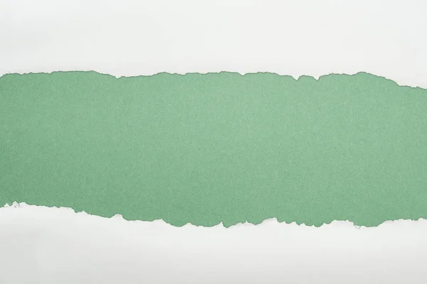 Papier texturé blanc déchiqueté avec espace de copie sur fond vert — Photo de stock