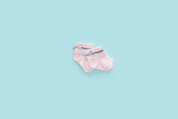 Top view of pink socks on blue pastel background with copy space — Stock Photo