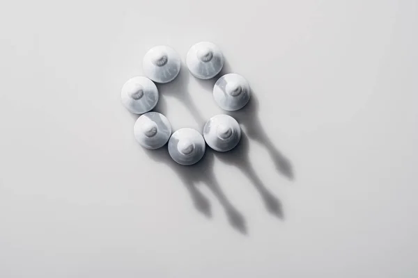 Top view of chess figures in circle with shadows on white background — Stock Photo