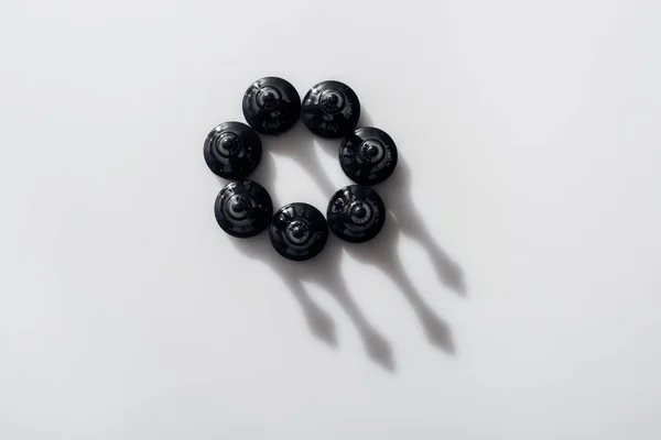 Top view of black chess figures in circle with shadows on white background — Stock Photo